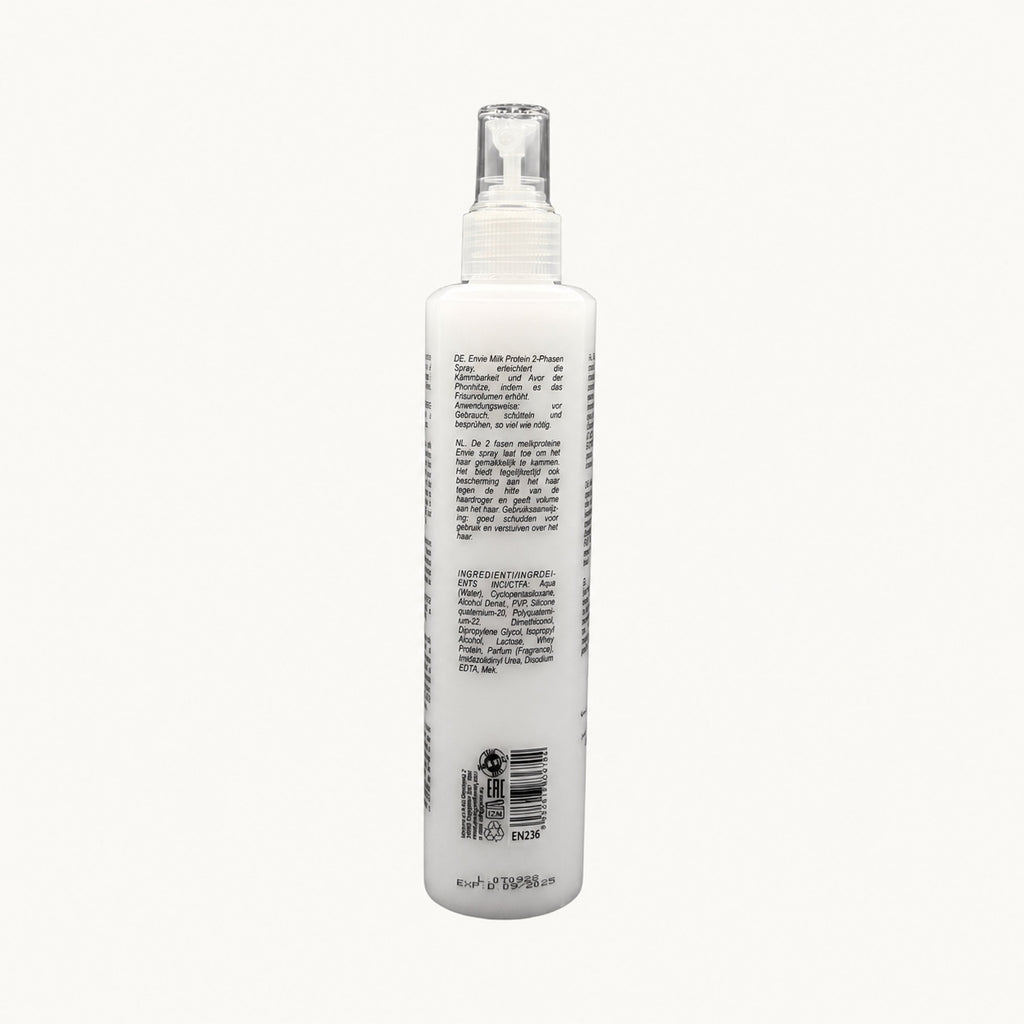 Envie Milk Districante Bifasico — flacone spray su fondo crema