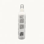 Envie Milk Districante Bifasico — flacone spray su fondo crema