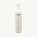 Envie Milk Districante Bifasico — flacone spray su fondo crema